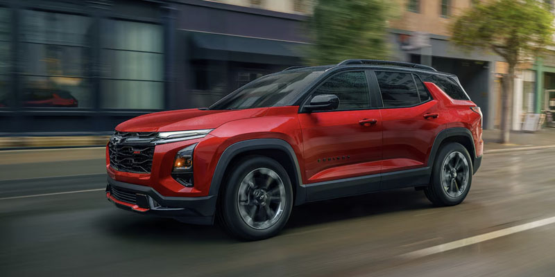 red chevy equinox driving through the city